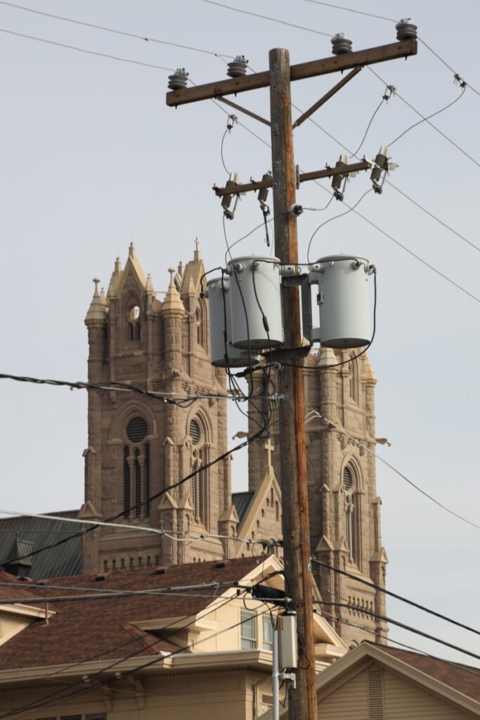 a couple of buckets sitting on top of a power pole